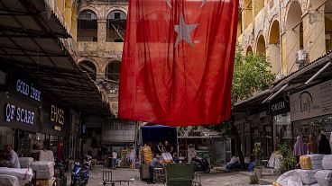 Workers upload goods in a truck in a street market at Istanbul's Eminonu commercial area in May