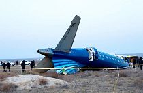 a part of Azerbaijan Airlines' Embraer 190 lies on the ground near the airport of Aktau, Kazakhstan, 26 December 2024
