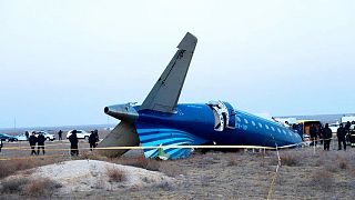 a part of Azerbaijan Airlines' Embraer 190 lies on the ground near the airport of Aktau, Kazakhstan, 26 December 2024