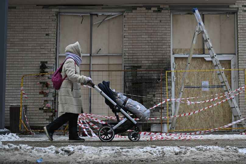 A woman walks past the apartment building where Igor Kirillov was killed in Moscow, 18 December, 2024