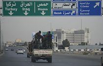 Syrian fighters travel on vehicles, as they patrol at a highway, in Damascus, Syria, Thursday, Dec. 26, 2024.