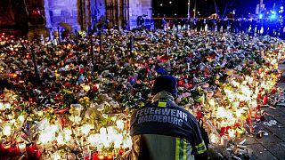 Flowers are laid in front of the Johannis church near the Christmas Market in Magdeburg, Germany, Monday, Dec. 23, 2024