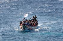 Migrants crowd a wooden boat as they sail to the port in La Restinga on the Canary Island of El Hierro, Spain, on 18 August 2024.