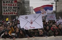 People stopping traffic, stand in silence during ongoing protests that erupted after a concrete canopy fell last month and killed 15 people in front of a government building