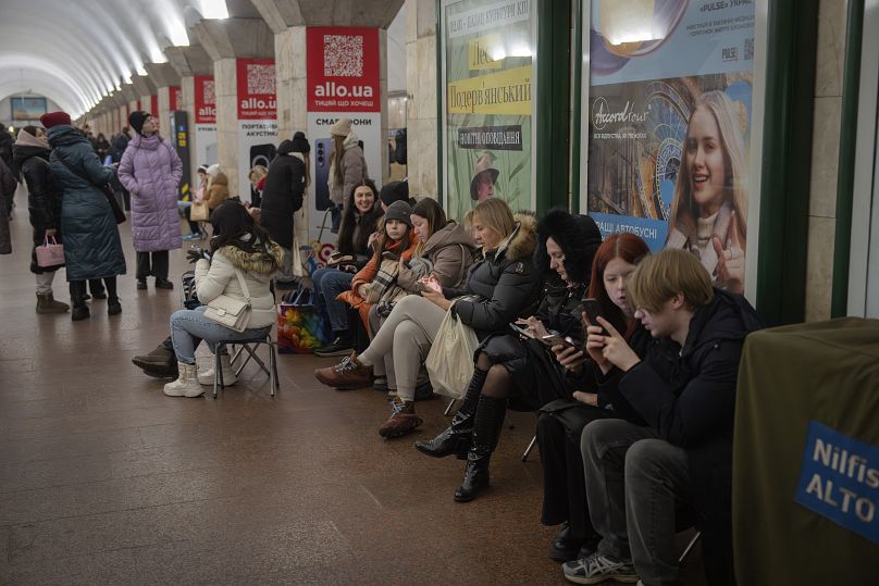 People hide in a metro station during a Russian missile attack alert on Christmas Eve in Kyiv, 24 December, 2024