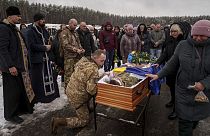FILE - Funeral where serviceman Roman bids farewell to his comrade Serhii Solovyov who was killed in in Kursk, Russia. Irpin, Kyiv region, Ukraine, Nov. 21, 2024
