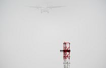 A plane lands in the mist at Cardiff Airport, in Cardiff, Wales, Saturday, Dec. 28, 2024.