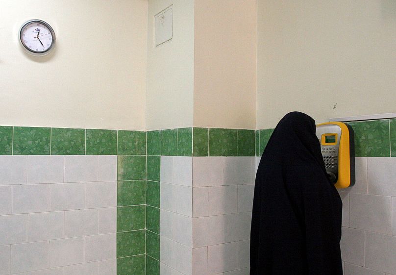 An female Iranian prisoner makes a call in a corridor in Evin Prison in Tehran, 13 June, 2006