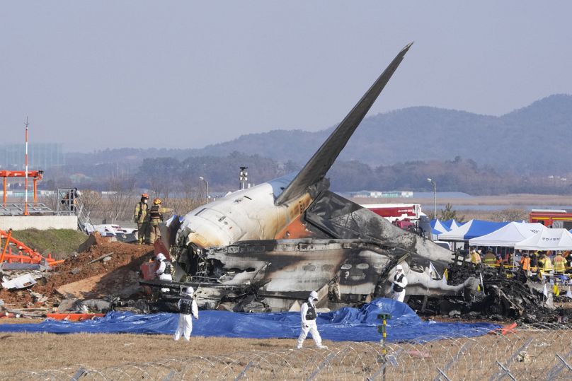 Firefighters and rescue team members work near the wreckage of a passenger plane at Muan International Airport in Muan, South Korea, Sunday, Dec. 29, 2024.