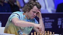 FILE - Norwegian Magnus Carlsen of SG Alpine Warriors plays Poland's Jan-Krzysztof Duda of Chingari Gulf Titans during Global Chess League, July 1, 2023, in Dubai, UAE