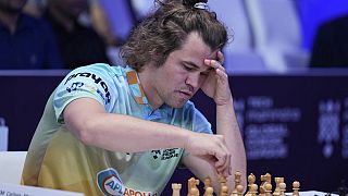 FILE - Norwegian Magnus Carlsen of SG Alpine Warriors plays Poland's Jan-Krzysztof Duda of Chingari Gulf Titans during Global Chess League, July 1, 2023, in Dubai, UAE