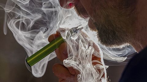 FILE - A man vapes on a disposable electronic cigarette in Brussels on Dec. 12, 2024, ahead of Belgium's ban on the sale of disposable vapes as of Jan. 1, 2025. 