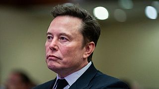 Elon Musk listens as President-elect Donald Trump speaks during a meeting with the House GOP conference, Wednesday, Nov. 13, 2024, in Washington. 