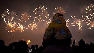 A child on his father's shoulders admires the New Year fireworks in Liuyang, China, 28.12.2024
