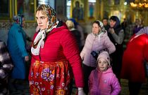 A woman leaves at the end of a religious service inside the Saint John the Baptist cathedral in Comrat, the capital of Gagauzia, an autonomous part of Moldova, 2 Nov 2024