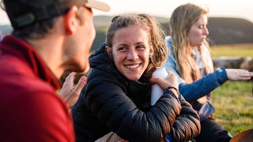 Lewicka celebrating after completing a sea swimming and half-marathon challenge in Exmoor National Park, UK