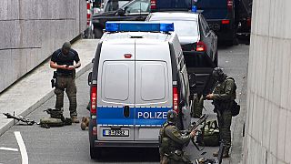 Police stand in front of the "Forum Köpenick" during an operation in the Bahnhofstrasse, Tuesday, Oct. 6, 2020, in Berlin, Germany.
