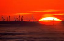 The sun sets next to a wind energy plant in the Taunus region near Frankfurt, Germany, November 2024.