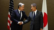 U.S. Secretary of State Antony Blinken, left, shakes hands with Japanese Foreign Minister Takeshi Iwaya as he holds a working lunch with him at a hotel in Tokyo.