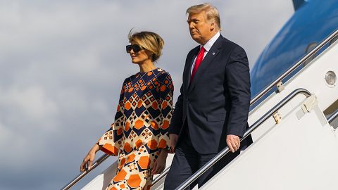 Former President Donald Trump, right, and Melania Trump disembark from their final flight on Air Force On