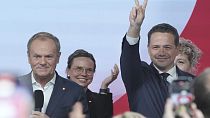 Rafał Trzaskowski, standing next to Prime Minister Donald Tusk (left)