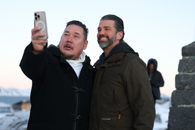 Donald Trump Jr., right, poses for a photo as he arrives in Nuuk, Greenland, Tuesday, Jan. 7, 2025