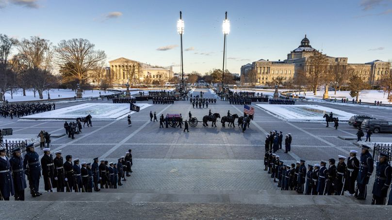 Un carro tirado por caballos con el ataúd cubierto con la bandera del expresidente Jimmy Carter llega al Capitolio de los Estados Unidos, el martes 7 de enero de 2025
