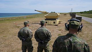 Slovakian soldiers stand by a gun of the Mantis (Modular, Automatic and Network Capable Targeting and Interception System) air defense weapon system.