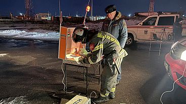 Firefighters and rescuers work at the industrial side damaged after Ukrainian drones' attack in Saratov, Russia.Wednesday, Jan. 8, 2025.