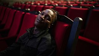 Abou Sangare, lead actor in "Souleymane's Story," poses for photographs after a premiere at the Louxor cinema in Paris, Tuesday, Oct. 8, 2024