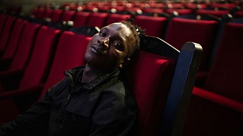 Abou Sangare, lead actor in "Souleymane's Story," poses for photographs after a premiere at the Louxor cinema in Paris, Tuesday, Oct. 8, 2024