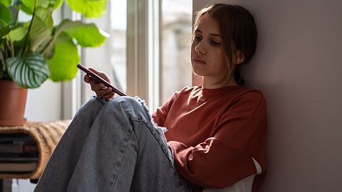 A teenage girl appears sad.