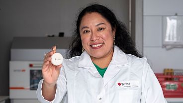 Empa scientist Carolina Reyes with the fungal battery that is encased in beeswax. 