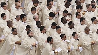FILE - Priests stand during Easter mass in St. Peter's Square celebrated by Pope Francis, at the Vatican, Sunday, March 31, 2024. (AP Photo/Alessandra Tarantino)