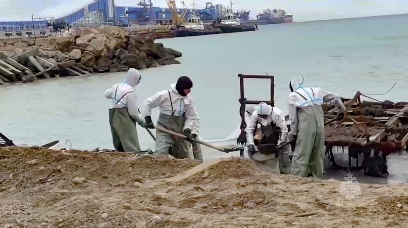 Emergency crews work to clean up fuel oil that spilled out of two tankers in the Kerch Strait, 12 January, 2025