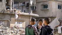 FILE: Palestinian children look at a damaged residential building following an overnight Israeli strike in Deir al-Balah, Gaza Strip, 8 January 2025