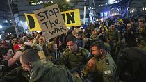 Police scuffle with demonstrators who block a road during a protest demanding a cease-fire deal and the immediate release of hostages held in the Gaza Strip by Hamas