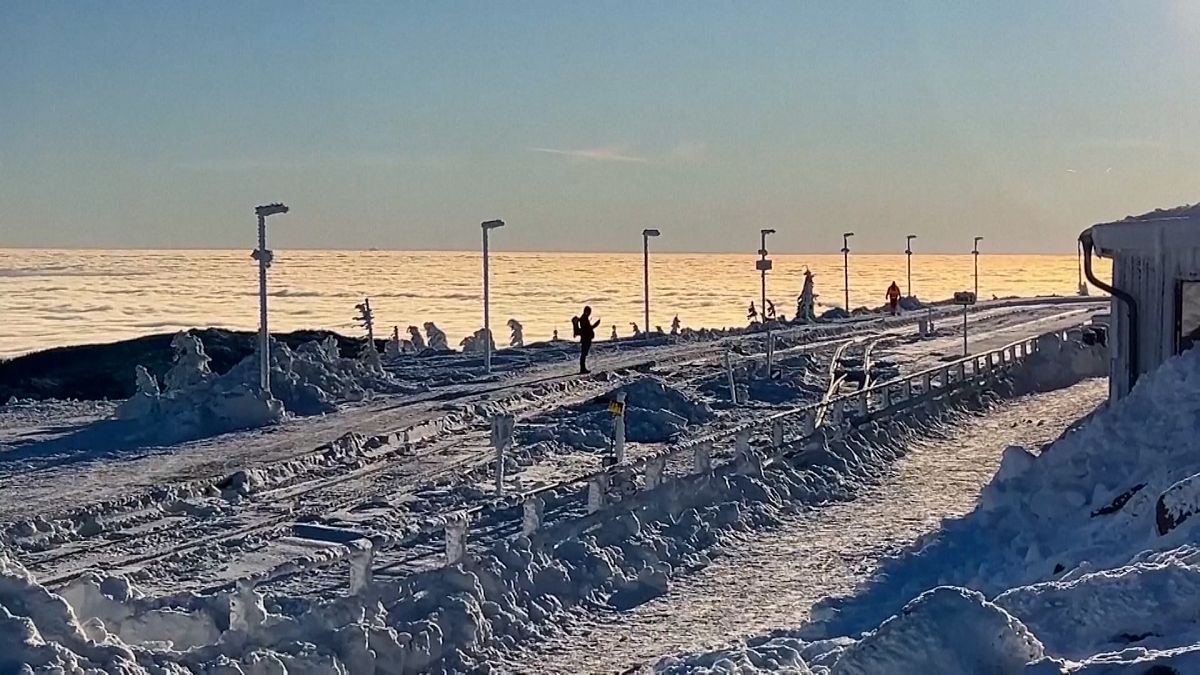 Video. Hikers enjoy early morning walk in snowy landscape in the Harz mountain range in northern Germany