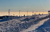 Hikers enjoy early morning walk in snowy landscape in the Harz mountain range in northern Germany