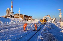 Railroad workers clear the tracks from snow on northern Germany's 1,142-meter high 'Brocken' at the Harz mountains near Schierke, Germany, Monday, Jan. 13, 2025.