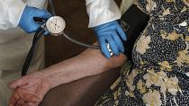 FILE - A doctor checks the blood pressure of A 94-year-old woman in Sant Sadurní d'Anoia, Catalonia region, Spain, Friday, July 31, 2020.