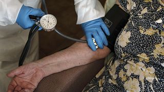 FILE - A doctor checks the blood pressure of A 94-year-old woman in Sant Sadurní d'Anoia, Catalonia region, Spain, Friday, July 31, 2020.