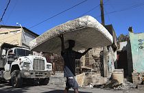 Residents move belongings out of their homes to escape gang violence in the Poste Marchand neighborhood of Port-au-Prince, Haiti, Tuesday, Dec. 10, 2024.