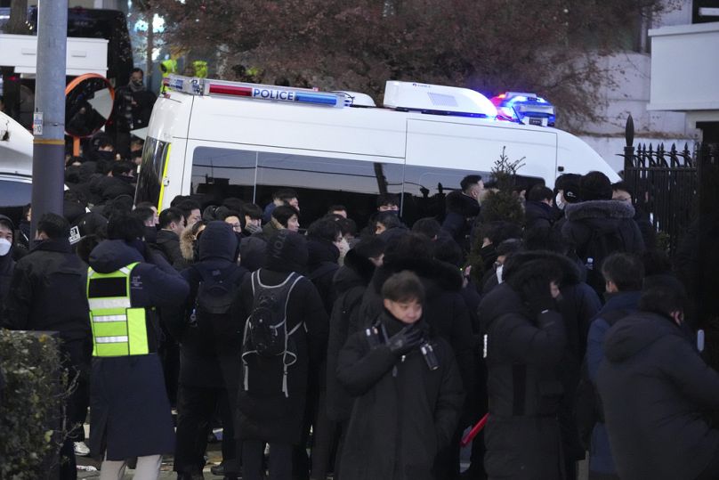 Police officers gather outside of the gate of the presidential residence in Seoul, South Korea, Wednesday, Jan. 15, 2025