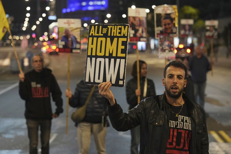 Israeli protesters call for Hamas to release hostages outside the Ministry of Defence headquarters in Tel Aviv, 17 December, 2024