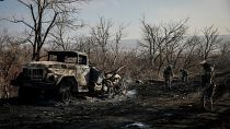 Ukrainian servicemen collect damaged ammunition on the road at the front line near Chasiv Yar town, in Donetsk region, Ukraine, on Jan. 10, 2025.