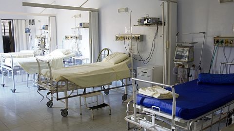 Empty hospital beds are shown.
