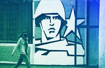 FILE: A woman walks past the Operational Group of Russian Forces headquarters in Tiraspol, the capital of the breakaway region of Transnistria, in Moldova, 1 November, 2021