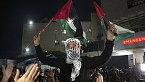 Palestinians celebrate the announcement of a ceasefire deal between Hamas and Israel in Deir al-Balah, central Gaza Strip, Wednesday, Jan. 15, 2025