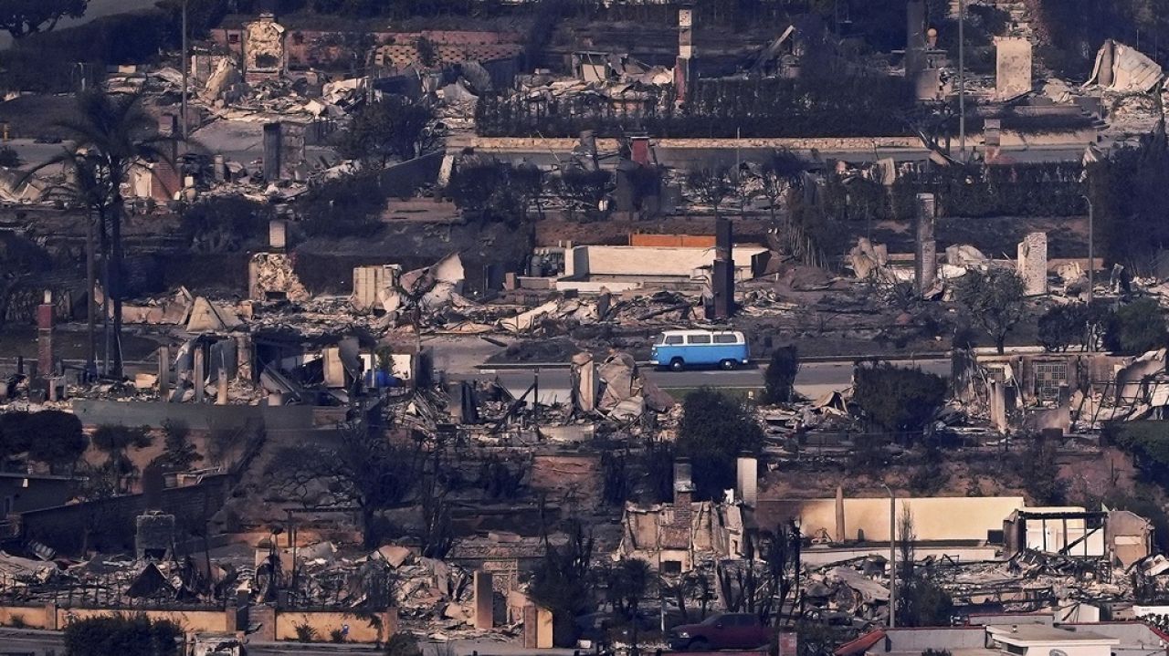 A Volkswagen bus sits among burned out homes, Jan. 9, 2025, in Malibu, Calif.